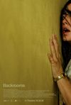 Backrooms poster. A mustard-yellow wallpapered wall takes up the majority of the space. A distraught-looking woman is pressed up against it.